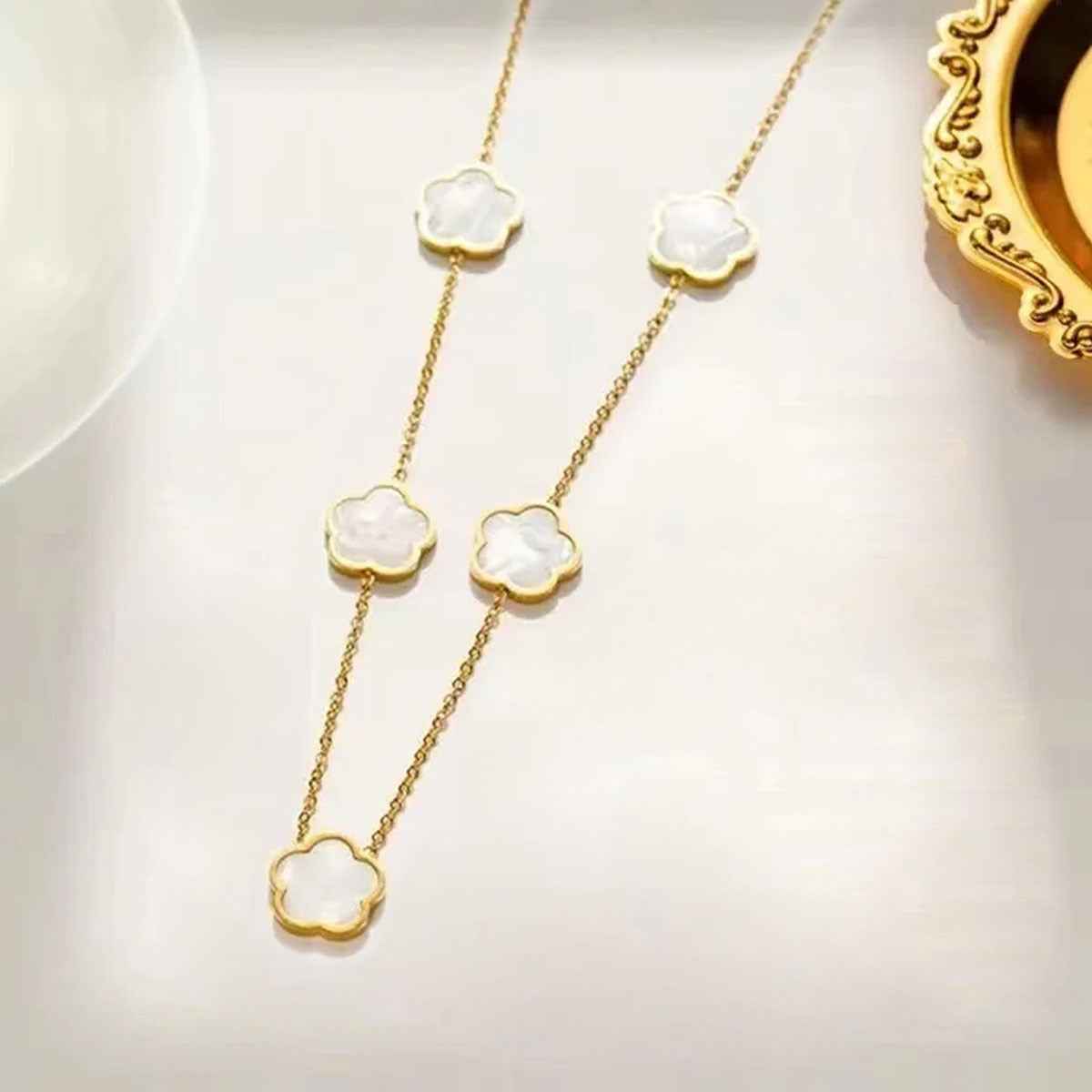 (Copy) Stainless Steel Parthenocissus Grass Electroplated Shell 18K Gold Plated Simple Style O-Shaped Chain necklace. In black and white.